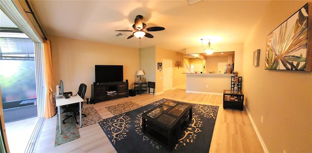 living room with hardwood / wood-style floors and ceiling fan