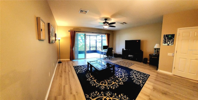 living room featuring hardwood / wood-style floors and ceiling fan