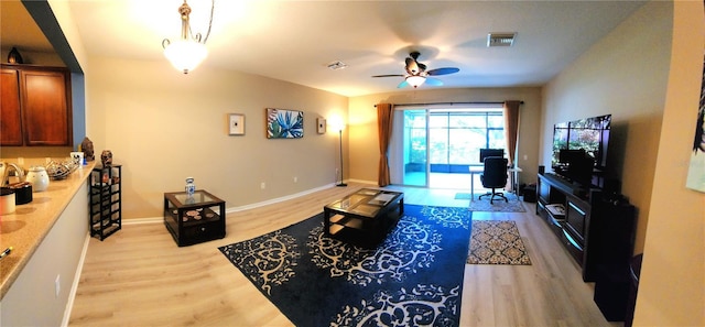 living room featuring ceiling fan and light wood-type flooring