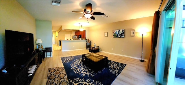 living room featuring ceiling fan and light hardwood / wood-style floors