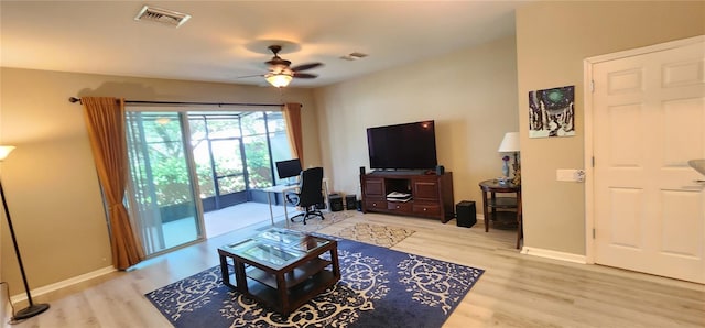 living room with ceiling fan and light wood-type flooring