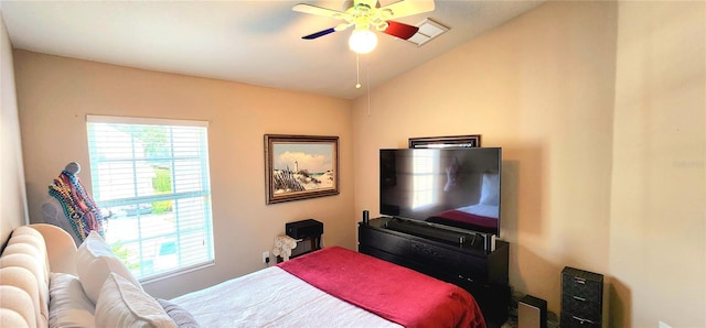 bedroom featuring multiple windows, vaulted ceiling, and ceiling fan