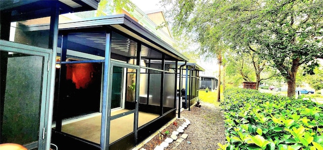 view of side of property with a sunroom