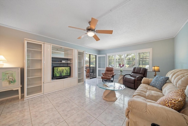 tiled living room with a textured ceiling, ceiling fan, and ornamental molding