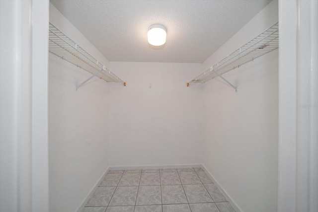 walk in closet with light tile patterned floors