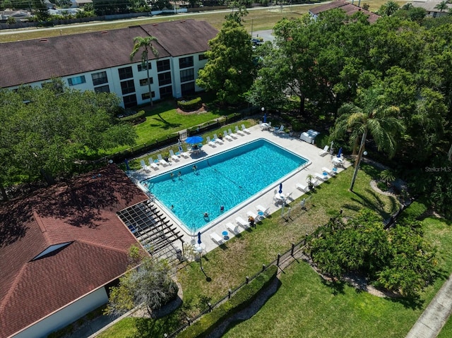 view of pool with a patio area and a lawn