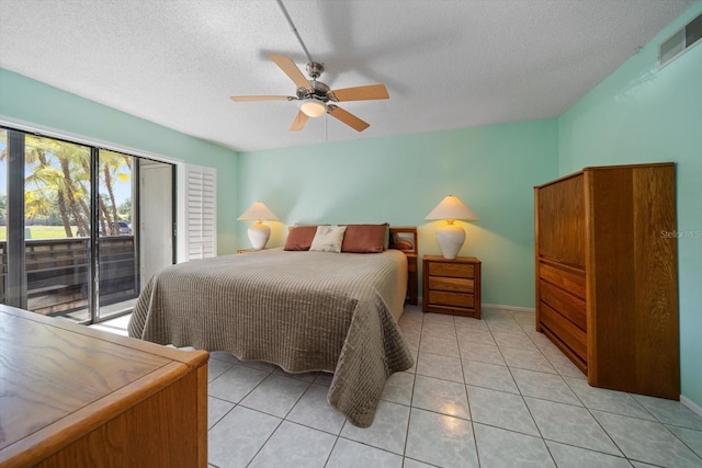 bedroom featuring access to outside, ceiling fan, light tile patterned floors, and a textured ceiling