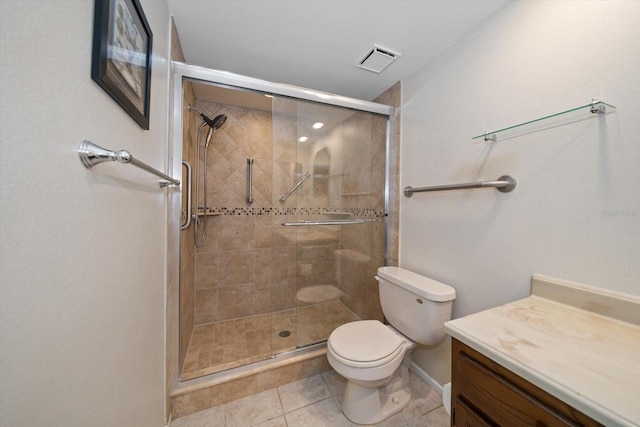 bathroom with tile patterned floors, vanity, toilet, and an enclosed shower