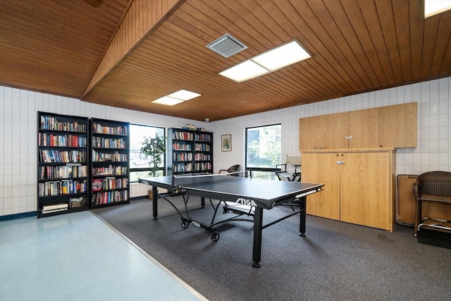 rec room featuring wood ceiling and tile walls