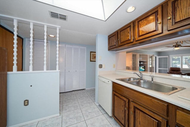 kitchen with white dishwasher, ceiling fan, light tile patterned floors, and sink