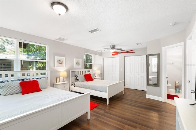 bedroom featuring a textured ceiling, ceiling fan, dark hardwood / wood-style flooring, and ensuite bathroom