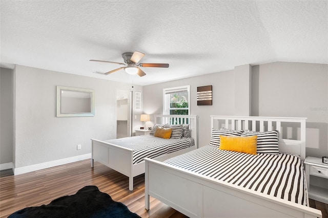 bedroom featuring lofted ceiling, ceiling fan, a textured ceiling, and hardwood / wood-style flooring