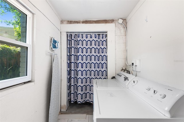 laundry area featuring washing machine and clothes dryer