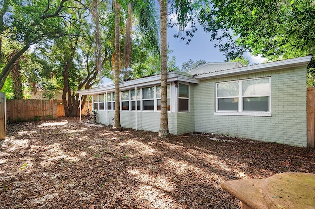 view of side of home featuring a sunroom