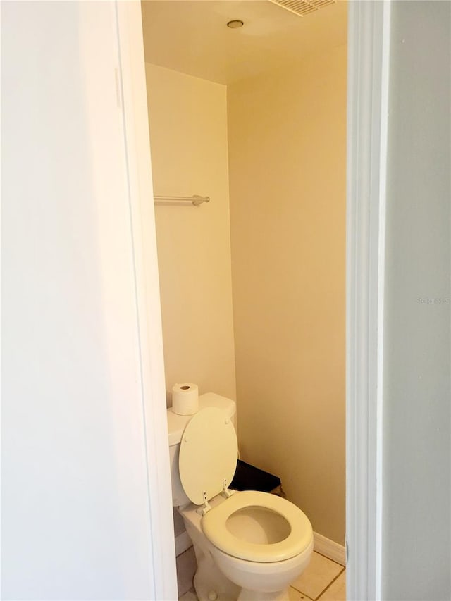 bathroom with tile flooring and toilet