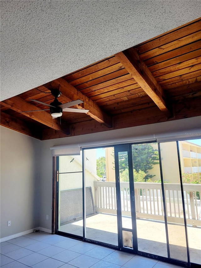 tiled spare room with ceiling fan, beam ceiling, and wooden ceiling