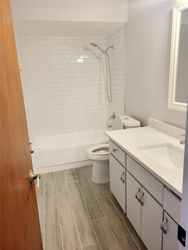 318 Windrush Blvd Unit 9, Indian Rocks Beach, FL 33785 - full bathroom with vanity,  shower combination, toilet, and wood tiled floors