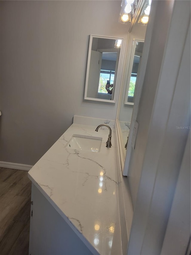318 Windrush Blvd Unit 9, Indian Rocks Beach, FL 33785 - bathroom with vanity and wood finished floors