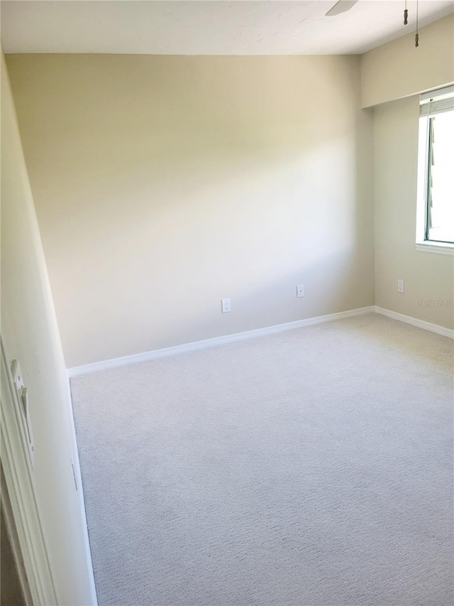 carpeted empty room featuring ceiling fan