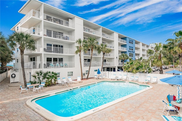 view of swimming pool with washer / dryer and a patio