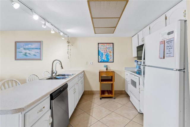 kitchen with white cabinetry, sink, white appliances, and kitchen peninsula