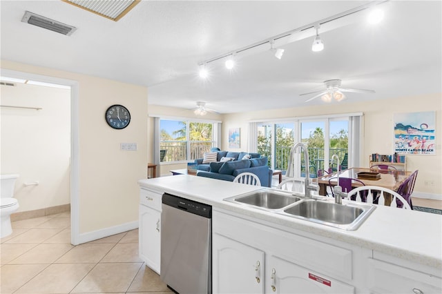 kitchen featuring ceiling fan, white cabinetry, dishwasher, sink, and light tile patterned floors