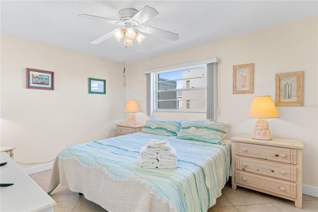 tiled bedroom featuring ceiling fan