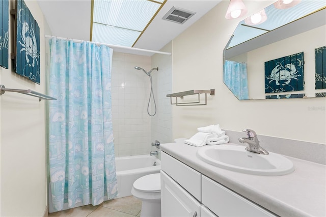 full bathroom with tile patterned flooring, shower / tub combo, vanity, and toilet