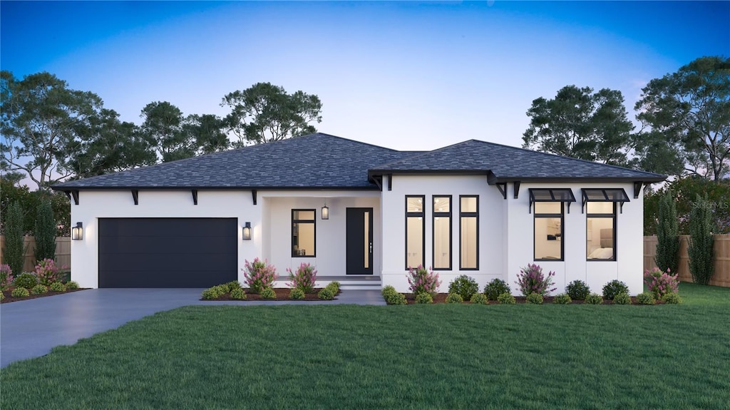 view of front facade featuring a front lawn and a garage