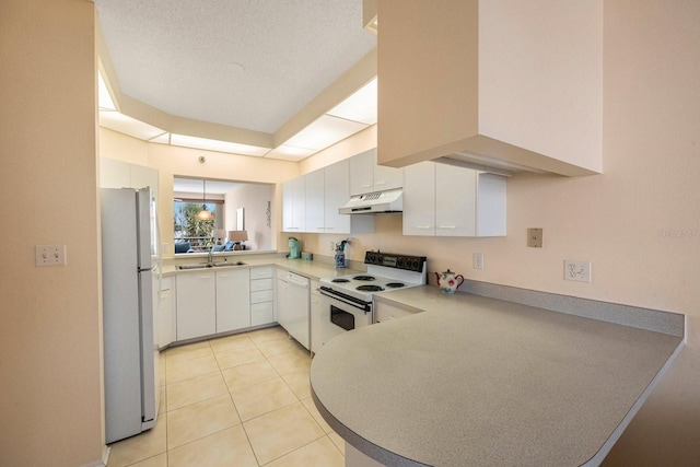 kitchen featuring white cabinetry, light tile patterned flooring, white appliances, and kitchen peninsula