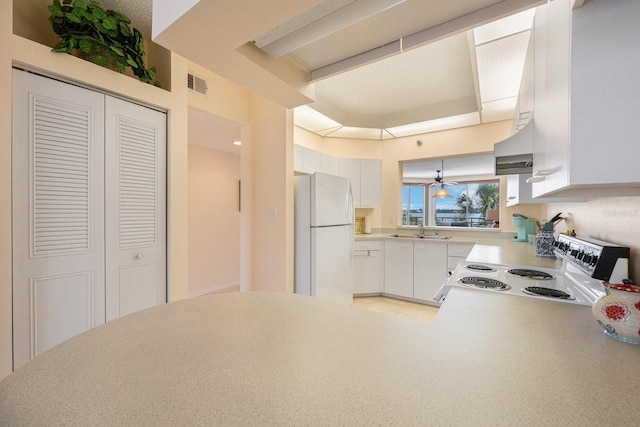 kitchen featuring sink, ceiling fan, white cabinetry, range with electric cooktop, and white fridge