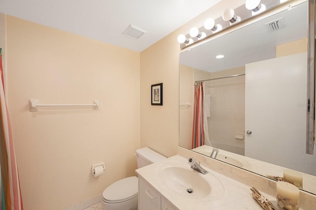 bathroom featuring walk in shower, vanity, toilet, and tile patterned flooring