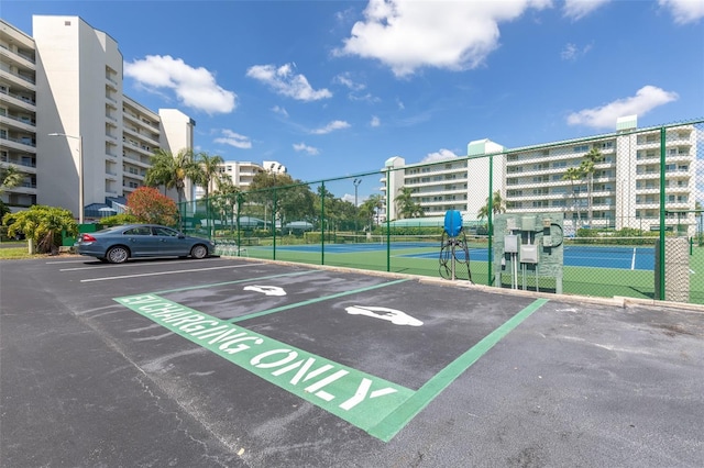 view of parking / parking lot featuring tennis court