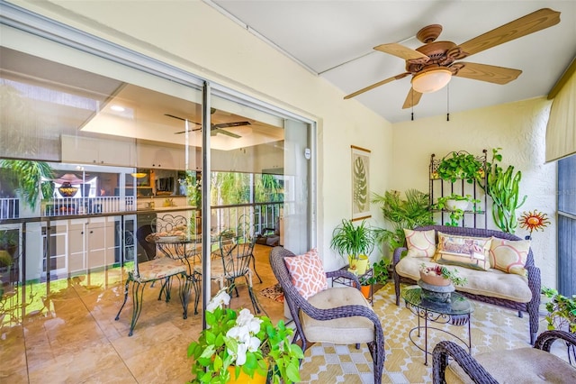 sunroom featuring a ceiling fan