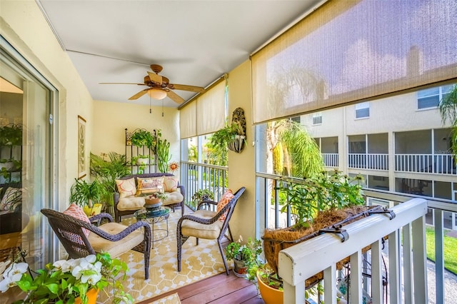 sunroom / solarium featuring a ceiling fan