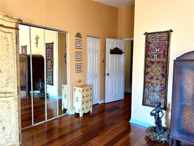 bedroom featuring dark wood-style floors and baseboards