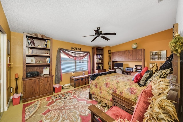 bedroom featuring baseboards, a ceiling fan, vaulted ceiling, and a textured ceiling