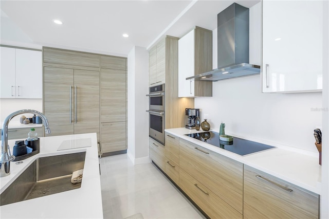 kitchen with white cabinetry, sink, wall chimney exhaust hood, stainless steel double oven, and black electric cooktop