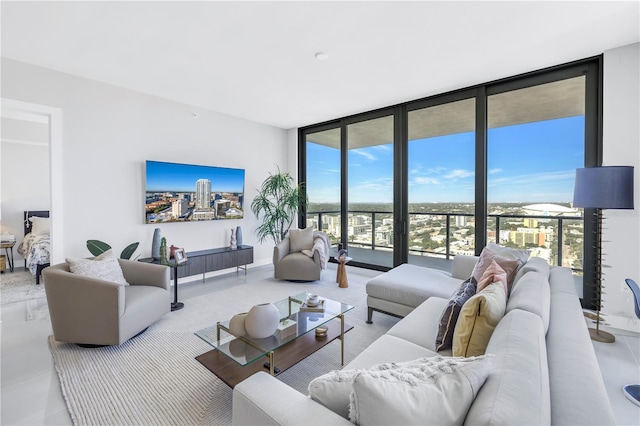 living room featuring floor to ceiling windows and a healthy amount of sunlight