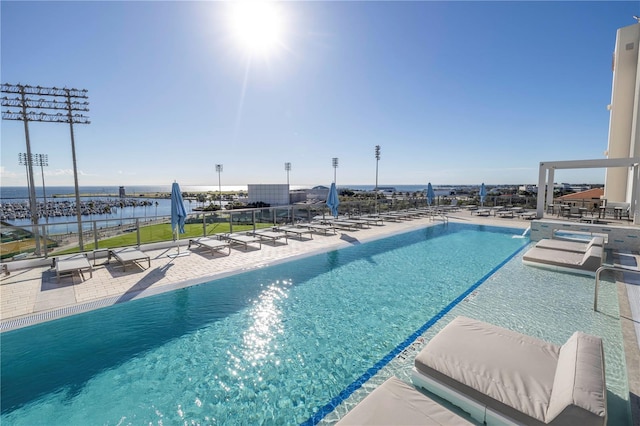 view of pool with a patio and a hot tub