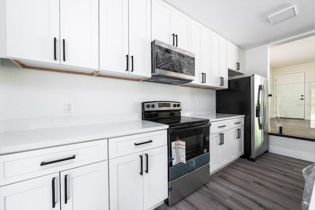 kitchen with stainless steel appliances, white cabinetry, dark hardwood / wood-style floors, and light stone counters