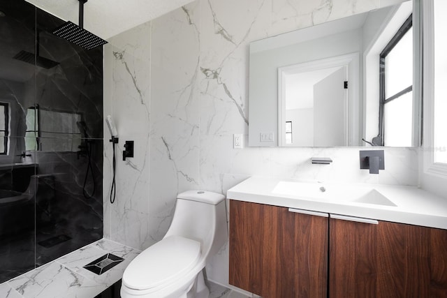 bathroom with tiled shower, vanity, toilet, and tile walls