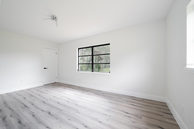 unfurnished room with light wood-type flooring