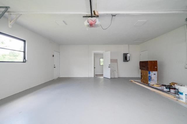 garage with a garage door opener and electric panel