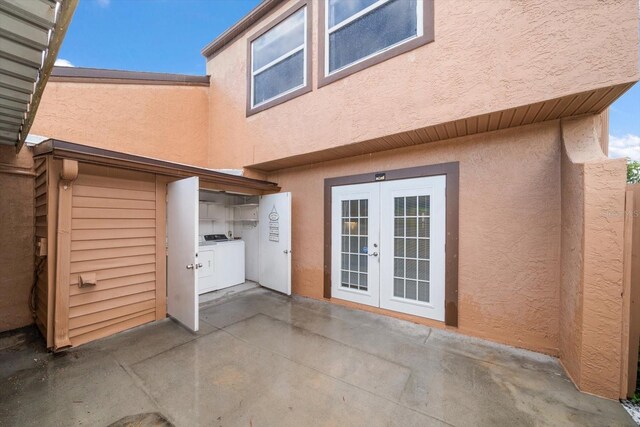 rear view of house with a patio area, independent washer and dryer, and french doors