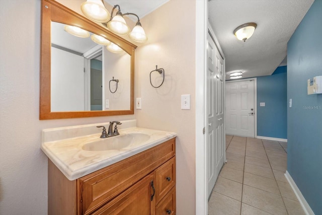 bathroom featuring tile floors, a textured ceiling, and vanity