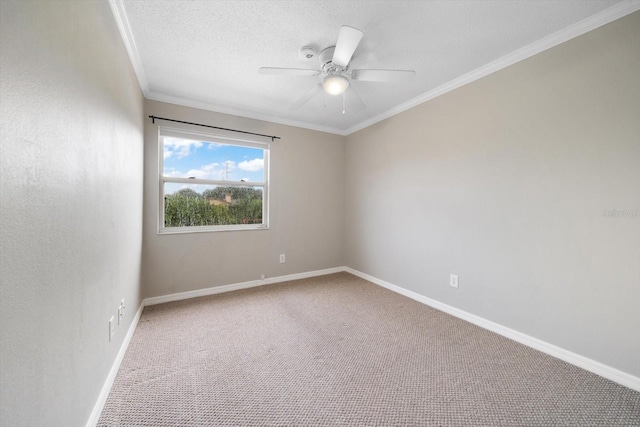 spare room with a textured ceiling, ornamental molding, carpet, and ceiling fan