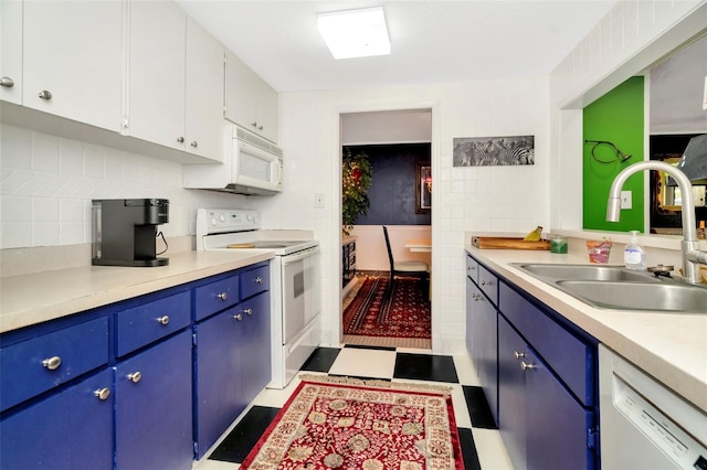 kitchen with blue cabinetry, sink, backsplash, white appliances, and white cabinets