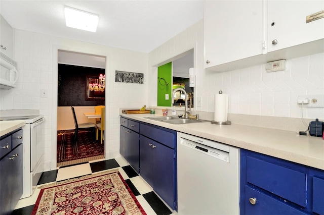 kitchen with blue cabinetry, white cabinets, white appliances, and sink