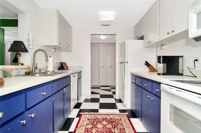 kitchen featuring blue cabinetry, sink, white cabinets, and white appliances